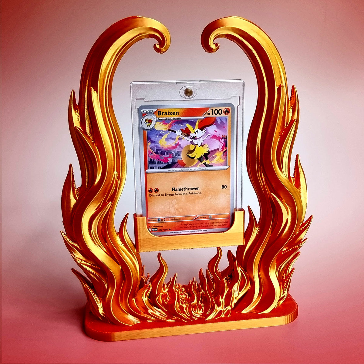 Blazing Arc card holder in gold and red, a trading card in its clear one-touch case framed by sculpted flames