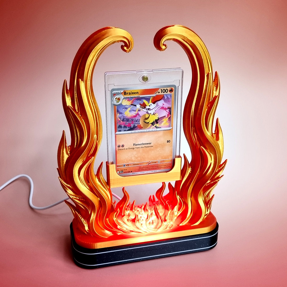 The illuminated base switched on, light glowing up through the low flames at the foot of the holder