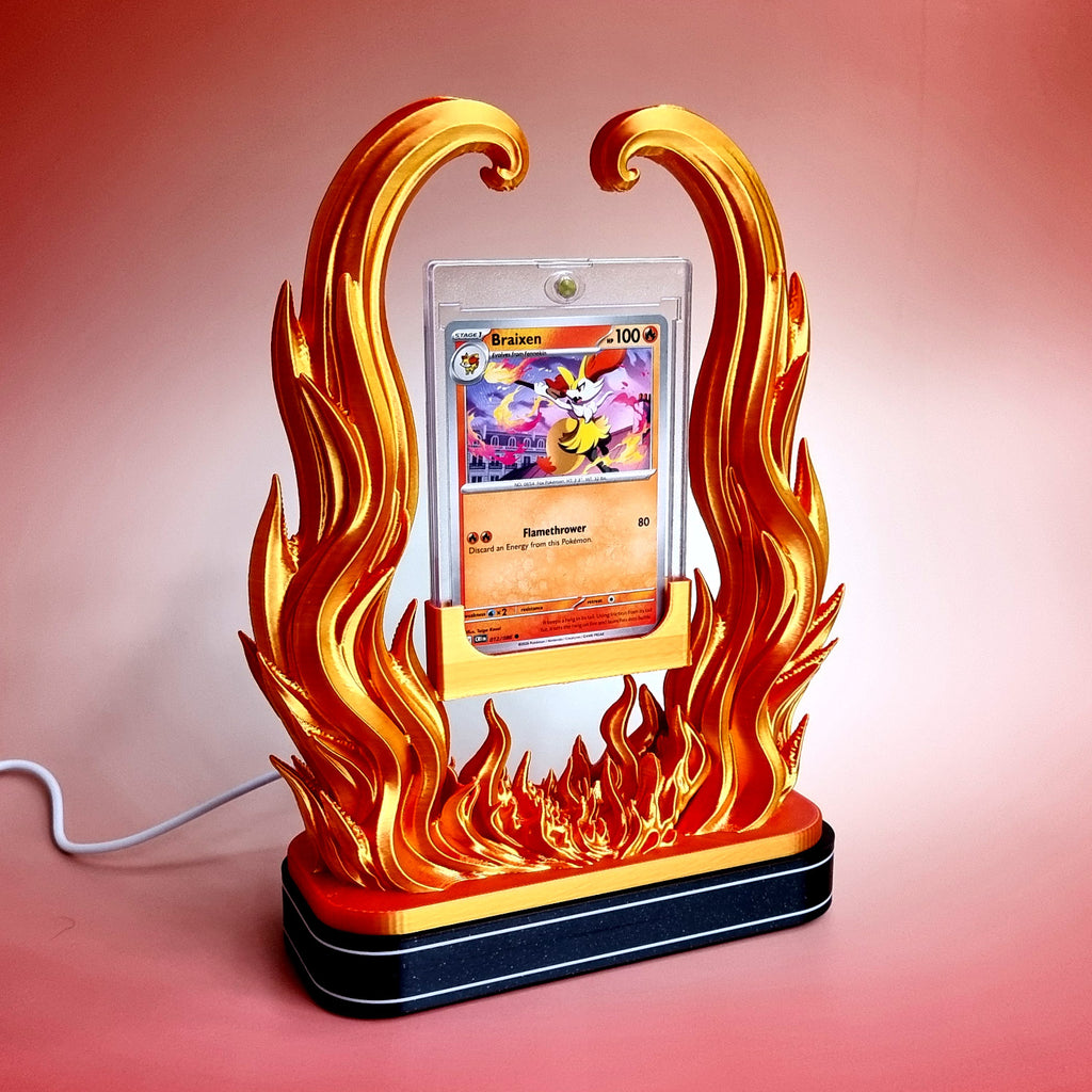 The gold and red flame holder standing on the black illuminated base, light off, USB cable running off to the side